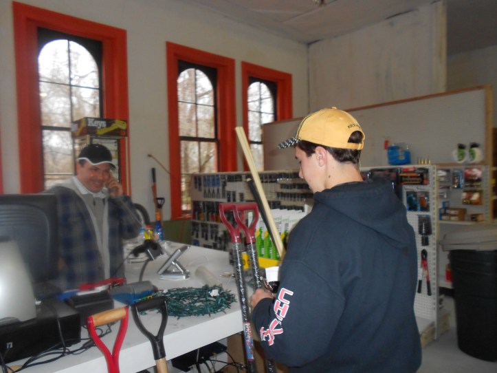 Shane Mrakovich on phone setting up retail hardward store