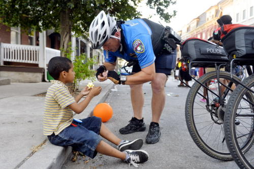 York City Police lieutenant Erik Kleynen, right, attaches a pin to a toy deputy badge given to him by Juan Andrew Martinez, 6, during National Night Out on Tuesday, Aug. 4, 2015, in the 200 block of East College Street in York City. Various municipalities and police departments in York County teamed up to host National Night Out, an annual, nationwide event designed to strengthen relationships between communities and police. York City, the York City Police Department and other community and religious groups hosted 27 National Night Out block parties throughout the city. Chris Dunn Ñ Daily Record/Sunday News