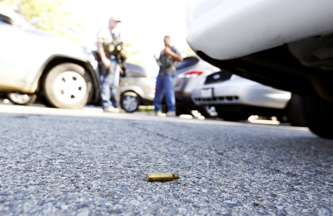 A spent cartridge lies on the ground as police officers secure the area after at least one person opened fire at a social services agency in San Bernardino, California December 2, 2015. The San Bernardino Police Department said on Twitter that it had "confirmed 1 to 3 possible suspects" and multiple victims in the shooting. The agency called it an "active shooter" incident.  REUTERS/Mario Anzuoni - RTX1WWIU